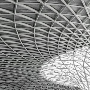 Stacked steel inventory bags and metal coils in industrial warehouse