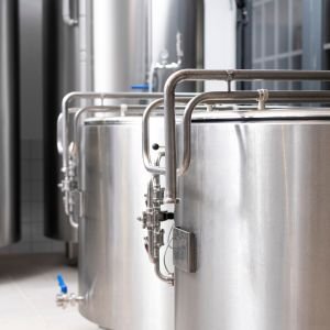 Steel beams and metal sheets stacked in industrial warehouse